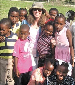Courtesy Photo

Prescott resident Kari Hull basks in the warm welcome she received from children in Lescayes, Haiti. Hull traveled to Haiti in January as a program coordinator for the World Children¹s Relief charitable organization.