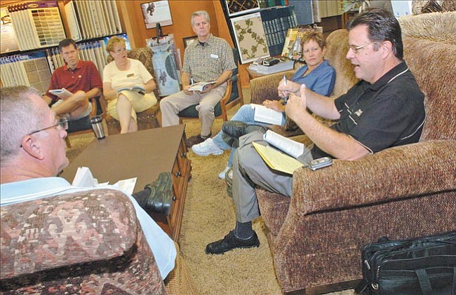 The Daily Courier/Nathaniel Kastelic
Dan Hussey, right, owner of B & L Flooring America, leads a book club at his business in Prescott Valley Friday. The club is reading the book ‘Getting Things Done: The Art of Stress-Free Productivity’ by David Allen.