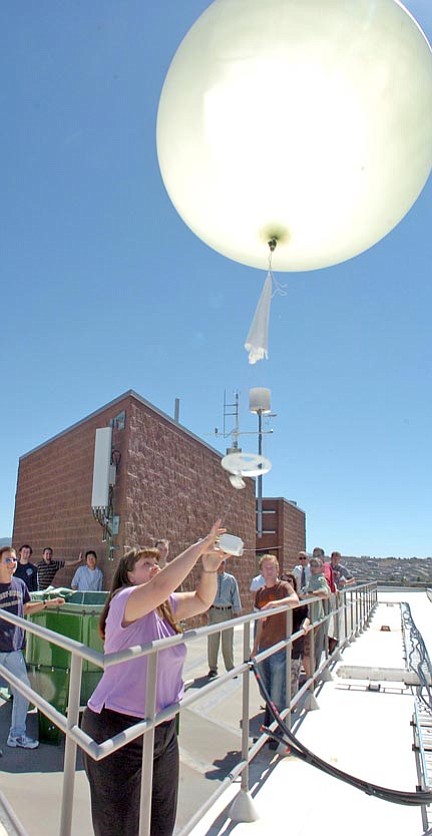 Kathryn Weik, a meteorology and aeronautics double-major senior student, launches a weather balloon from the top of Building 74 at Embry-Riddle Aeronautical University to record temperature, humidity and air pressure in Prescott Tuesday.

The Daily Courier/Nathaniel Kastelic