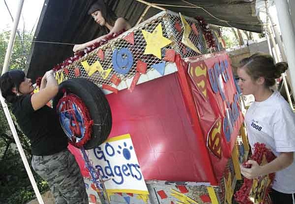 The Daily Courier/Les Stukenberg
Prescott High School seniors, from left, Brianna Vicente, Piper Stoeckel and Ciara Larsen decorate their classes float Wednesday night for the homecoming parade.
