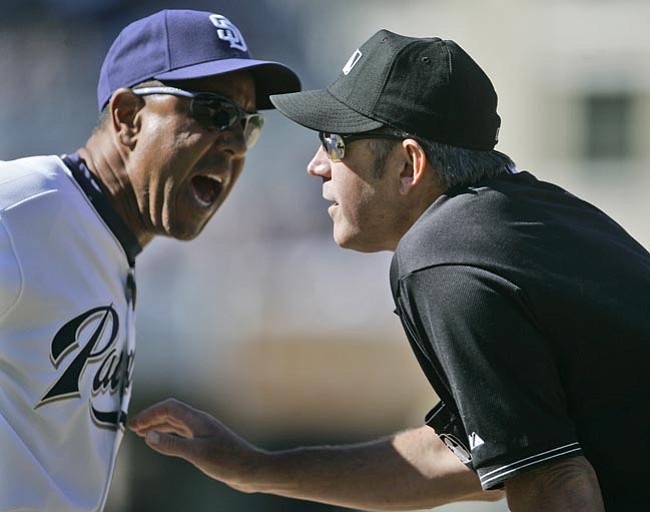 The Associated Press/<br>Lenny Ignelzi<br>San Diego first base coach Bobby Meacham, left, gives an earful to umpire Mike Winters during the controversial eighth inning of the Padres' 7-3 loss to the Rockies back on Sept. 23.