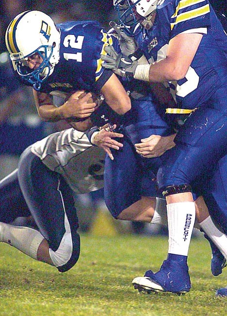 The Daily Courier/<br>Nathaniel Kastelic<br>Prescott QB Josh Chavez chugs through the defense of Cactus Shadows Friday night. Chavez tossed the game-winning TD to Keith Knudsen in the fourth quarter.