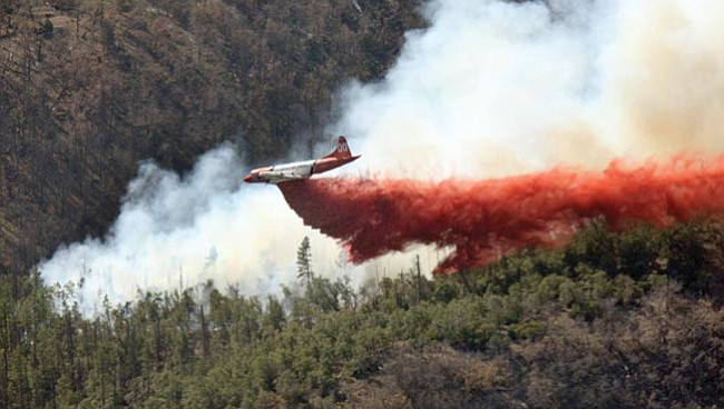 The Daily Courier/Les Stukenberg
Tanker 00 drops a load of retardent on the eastern edge of the August Fire approximately 10 miles South of Prescott near Palace Station Friday afternoon.

