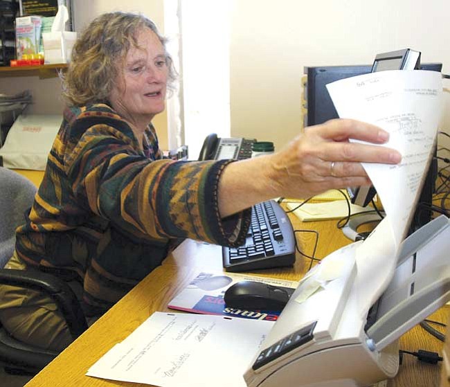 Kay Lauster, City of Prescott scanning clerk, inserts another document into a scanner that will put it into the Onbase System the city currently uses. Lauster said she is currently scanning contracts, ordinances, resolutions and city council packets.

The Daily Courier/Les Stukenberg