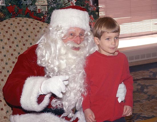 The Daily Courier/Jo.L. Keener 
Alex Cline, 5, of Prescott poses with Santa Claus at the Prescott Resort Saturday as they have a photo taken. Santa’s arrival is part of the holiday festivities at the resort.
