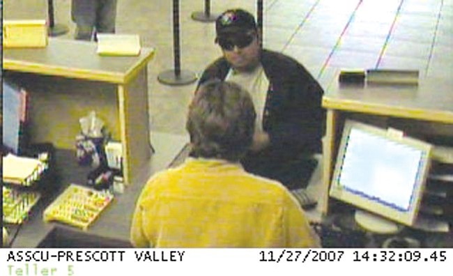 Courtesy
This security camera photo shows the man who slipped a note demanding money to a teller at Arizona State Credit Union Tuesday.