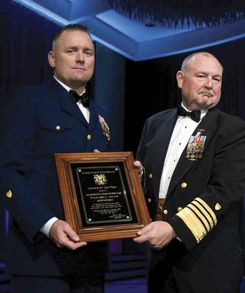 Officer 1st Class Wil Milam, an aviation survival technician (rescue diver) at Coast Guard Air Station Kodiak, receives the Coast Guard Foundation Individual Award for Heroism from Admiral Thad Allen, Commandant of the Coast Guard.