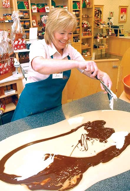 Joni Clickner of the Rocky Mountain Chocolate Factory mixes fudge ingredients.