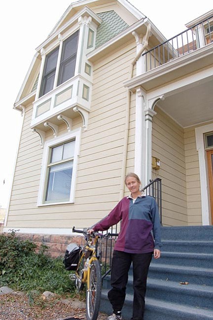 The Daily Courier/Cindy Barks
Sue Knaup, executive director of the new One Street organization, stands in front of the historic A.J. Head house, the Gurley Street building that will serve as bicycle advocacy group’s headquarters.