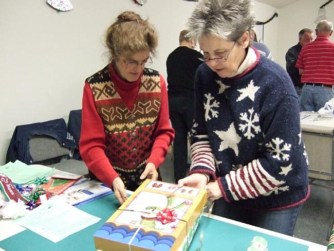 May Willimann and Sue Weisshauat, with the Prescott Antique Auto Club, wrap Christmas prevents for veterans at the Bob Stump VA Medical 
center. 

Courtesy/Janet Travis
