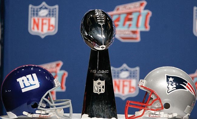 The Associated Press/<br>Stephan Savoia<br>
The Vince Lombardi Trophy, a sterling silver trophy created by Tiffany & Company, stands 20 3/4 inches tall, weighs 6.7 pounds and is valued more than $25,000.