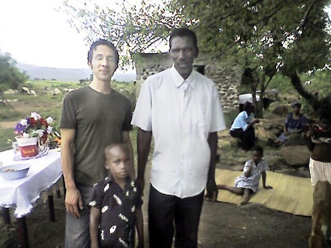 Courtesy<br>
Singer/songwriter Saul Kaye, left, sponsors Mayibongwe Mamba through the World Vision program. The boy’s grandfather poses with them in this photo taken in Swaziland.

