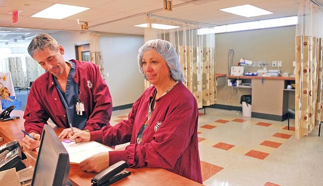The Daily Courier/Jo. L. Keener  
<br>
Tim Mohr, R.N., and Carleen Shelton, operating room director, check on a patient's status at the Tri City Surgery Center Tuesday afternoon.

