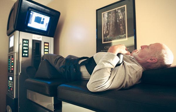 The Daily Courier/Les Stukenberg<br>
Jim Livingston has his spine stretched by an Axiom Worldwide DRX 9000 at the Mountain Valley Rehabilitation Hospital in Prescott Valley. The stretching helps to relieve the stress on the discs in his spine.