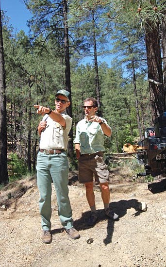 The Daily Courier/Doug Cook<p>
Prescott National Forest official Bill Cook, left, and Yavapai Trails Association member Rob Hehlen on Tuesday stand near the site of the new Aspen Creek Trailhead while discussing the work county crewmen are doing to clear the way for a gravel parking area next to Forest Road 9401L.