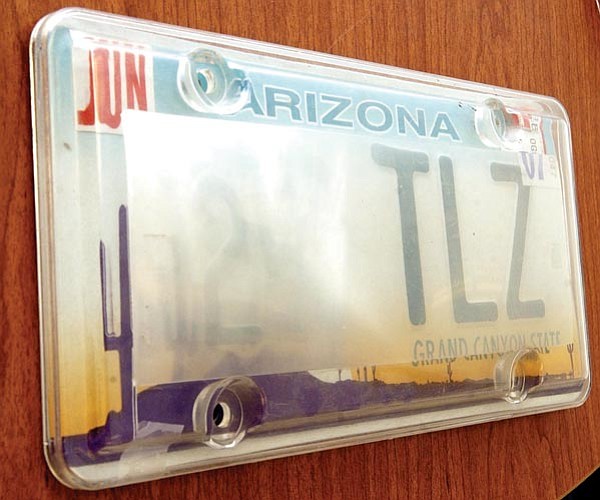 The Daily Courier/Nathaniel Kastelic<p>
This license plate cover, which obscures the plate number when viewed at an angle, is intended to defeat photo radar cameras, but violates Arizona Revised Statute 
28-2354B3, which requires license plates to be maintained so they are clearly legible.    

