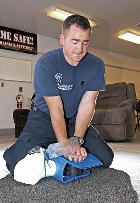 The Daily Courier/Jo. L. Keener 
Central Yavapai Fire District Firefighter Josh Barnum demonstrates CPR compressions on a training dummy Wednesday afternoon at Station 53.


