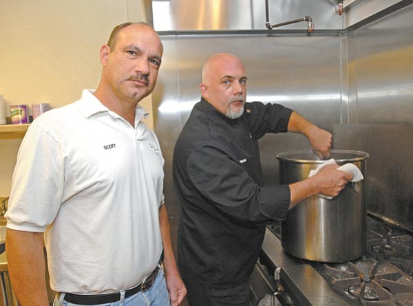 







The Daily Courier/Jo.L.Keener
Scott De Joseph, left, and Conan Matthews of A La Carte catering prepare food for an event Wednesday morning. 

