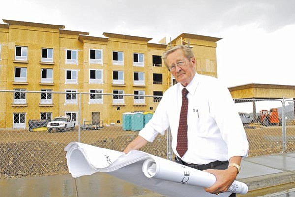 The Daily Courier/Jo. L. Keener<p>
Prescott Valley Mayor Harvey Skoog looks over plans for the new Comfort Suites located on North Crownpointe Drive. The new hotel is scheduled to open late fall.