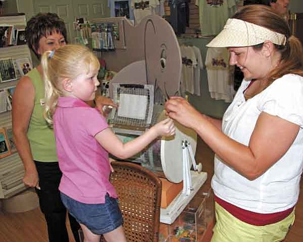 Courtesy photo/Heritage Park Zoological Sanctuary<p>
Four-year-old Madelyn Luttrell of Spokane, Wash., hands the winning raffle ticket to Heritage Park Zoological Sanctuary events coordinator Jennifer Woolnought June 30, while executive director Pat McLaren watches the proceedings.