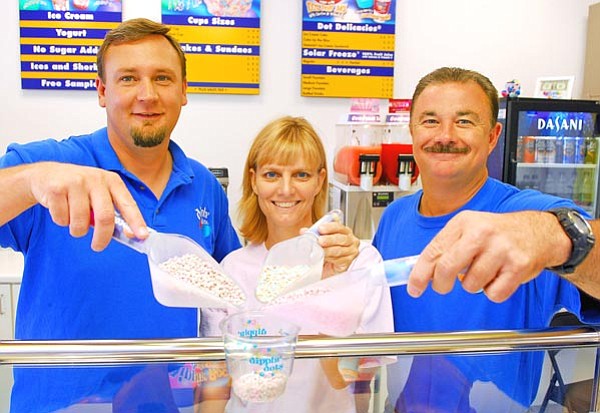 




Matt Hinshaw/The Daily Courier<p>
Forrest Hutton, Teresa Wells and Rob Wells have been in business together with Brandi Hutton, not pictured, since the opening of their store Dippin’ Dots in April.


