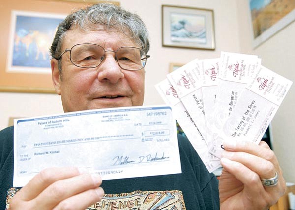 Matt Hinshaw/The Daily Courier<p>
Richard Kimball holds up a fraudulent check along with some tickets he was trying to sell on Craigslist for a Shakespeare event in Utah. Kimball received a check that was drastically over the amount he asked for the tickets and decided to contact the Prescott Police Department about a cyber-scam.
