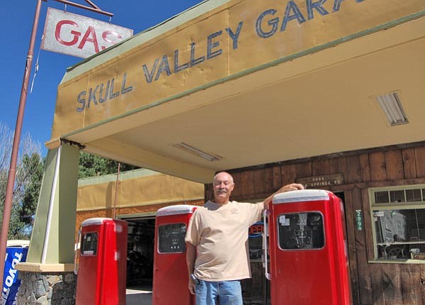 Bruce Colbert /The Daily Courier<br>
Skull Valley Gas Station owner Orrin Henderson dispenses gas from two 1950s fuel pumps. Henderson discovered the original “Skull Valley Garage” sign underneath a coat of old paint.