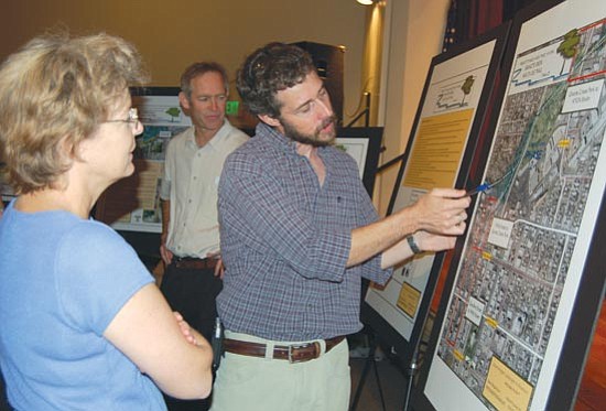 Cindy Barks/The Daily Courier<p>
During an unveiling of plans for a new section of the Prescott Greenways trail, Michael Byrd, executive director of the Prescott Creeks Preservation Association, points out a detail of the design to local resident Ellen Montgomery.


