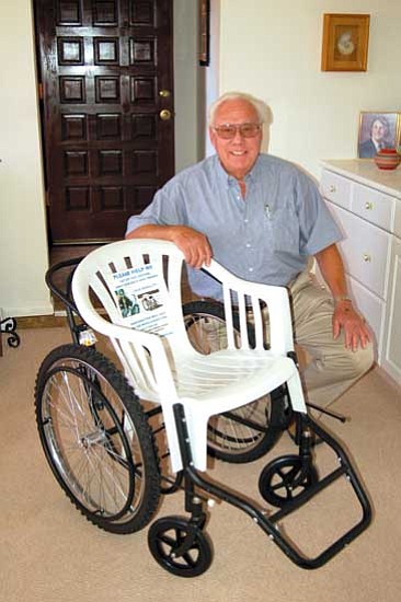 Jerry J. Herrmann/The Daily Courier<p>
Yavapai Hills resident Warren Root shows off the wheelchair that Don Schoendorfer, founder of Free Wheelchair Mission, designed for handicapped people in third world countries. The lawn chair seat makes the wheelchair inexpensive to manufacture and ship.