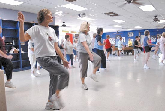 Jo. L. Keener/The Daily Courier<br>
Dody Richardson, left, and Mady Cianfrani work out in a 50's plus low impact aerobics class at the Prescott Valley Boys & Girls club. The work out class sponsored by Prescott Valley Parks and Recreation averages over 30 participants.