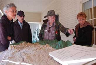 Bruce Colbert/The Daily Courier<p>
John Keeler, center, talks about railroad history with other members of the Dewey-Humboldt Historical Society. About two-dozen members attended a tour Tuesday of the Skull Valley Depot Museum.