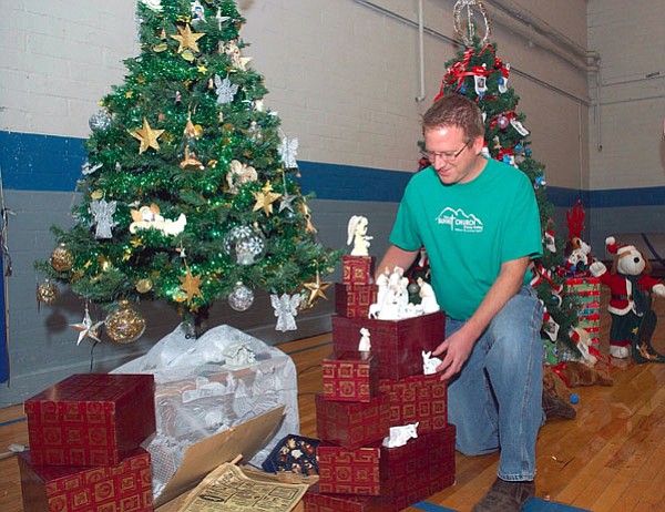 File Photo/The Daily Courier<br /><br /><!-- 1upcrlf2 -->Pastor Eric Woods of the Summit Church in Chino Valley, works on decorating the tree the church entered in the first Chino Valley Hometown Christmas in 2007. As chairman for the event, he is busy figuring out the layout for the estimated 60 Christmas trees individuals, businesses and organizations will enter in the event for people to view Friday and Saturday in the Heritage Middle School Gym.