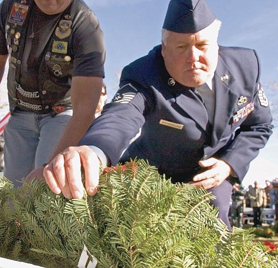 Matt Hinshaw/The Daily Courier<p>
U.S. Air Force Master Sergeant Logan C. Westmoreland lays a wreath at the Tomb of the Unknown Soldier Monument at the Prescott National Cemetery Saturday morning.