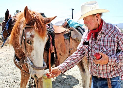 Sue Tone/Courtesy PV Tribune<p>
Kevin Leonard feeds Rusty on the final leg of his latest backcountry wilderness adventure. Leonard discusses his adventures and gives a slideshow 4 p.m. Friday at The Worm Bookstore in Prescott.