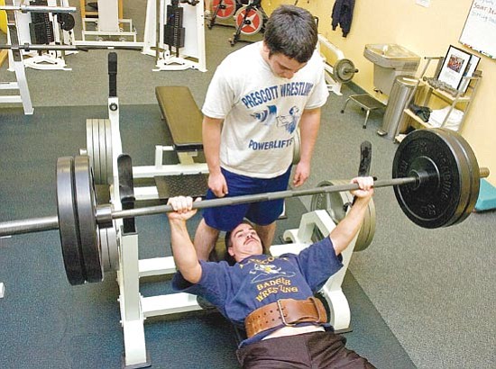 Matt Hinshaw/<br>The Daily Courier<br>Elias Sanchez spots Teddy Dwiggins as he bench presses 225 pounds at the Center for Physical Excellence. Dwiggins and Sanchez are members of the Prescott Area Strength Club.