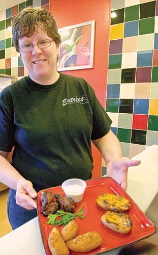 Matt Hinshaw/The Daily Courier<p>
Heidi Schueler, owner/manager of Entrees Made Easy, displays a finished set of Super Bowl party appetizers in Prescott Tuesday afternoon.