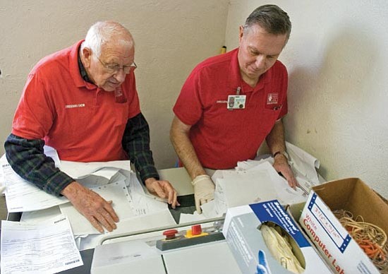Matt Hinshaw/The Daily Courier<p>
Yavapai Regional Medical Center volunteers Jim Stewart, left, and Jack Hoeft shred documents Thursday morning at YRMC West in Prescott.