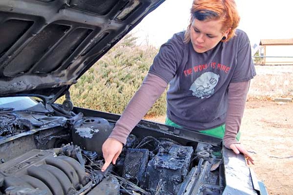 Bruce Colbert/The Daily Courier<br>
Desirae Bayless believes her car’s engine ignited because of a fuel line fix gone bad.
