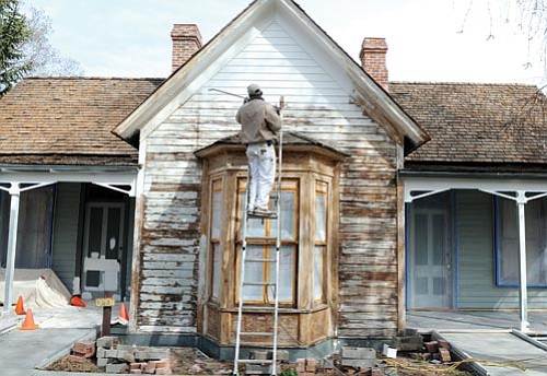 The Daily Courier/Les Stukenberg<p>
Baltazar Garcia, crew leader for Pinon Painting, applies a coat of primer to the historic Fremont House on the Sharlot Hall Museum campus in Prescott Friday. The company is doing the much-needed paint job for free after attempts to get state government help failed.