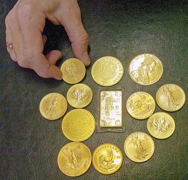 Matt Hinshaw/The Daily Courier<br>
Sandra Wolf, co-owner of Ancient and U.S. Coins LLC, displays a few "not collectible" gold pieces at the Prescott Antique Mall Thursday afternoon.  The "not collectible" coins are valued by their weight and the current market price of gold – not what kind of coin it is.