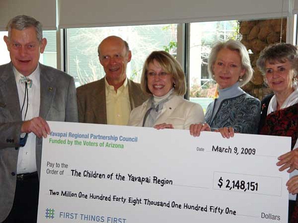 Courtesy photo<br>
Nadine Mathis Basha, president of the First Things First State Board, center, presents the Yavapai Region’s check to Prescott Mayor Jack Wilson; Dr. Eugene Thompson, Yavapai Region’s representative to the state board; Becky Ruffner, Yavapai Regional Partnership Council member; and Lora Lee Nye, Prescott Valley Town Council member. 
