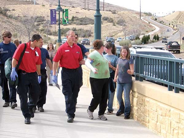 Jason Soifer/The Daily Courier<br>
Paramedics escort Lisa Montonati and her daughters, Christina and Talisa, to an ambulance on Stoneridge Drive in Prescott Valley after a bobcat attacked Lisa and Christina.