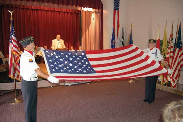 Jerry J. Herrmann/The Daily Courier<br>
American Legion Post No. 6 members Mike Schafer, left, and Dan F. Tillman prepare to show people at the Elks Flag Day ceremony at the Bob Stump Veterans Affairs Medical Center Sunday the 13 folds involved in folding the U.S. flag.