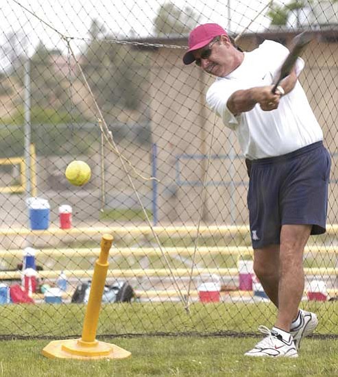 Les Stukenberg/<br>The Daily Courier<br>Mike Candrea runs hitting drills during a past camp in Prescott in this file photo from June 21, 2005. Candrea and the camp are taking a break in 2009.
