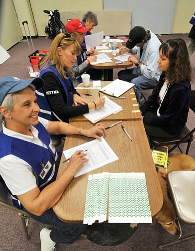 Les Stukenberg/The Daily Courier<br>
"Volunteer evacuees" register in the evacuation center during a Yavapai County Health Department and Red Cross evacuation drill at the Yavapai County Fairgrounds in Prescott Valley on Thursday. 
