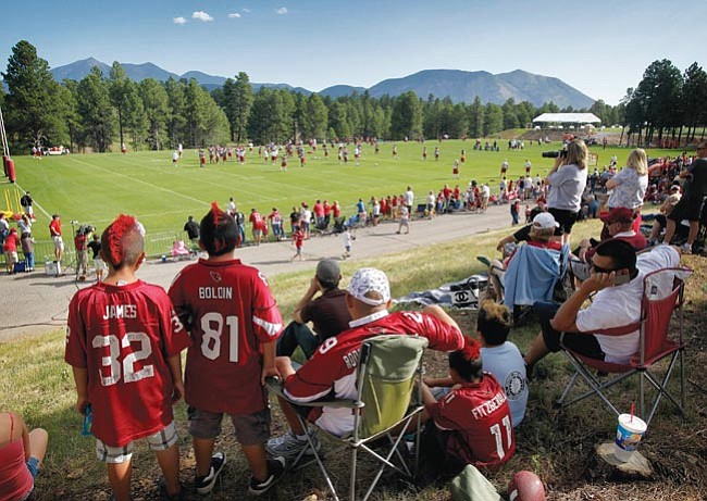 Matt York/The Associated Press
Fans watch the Arizona Cardinals run drills during training camp Friday in Flagstaff. 
