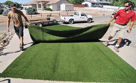 Les Stukenberg/The Daily Courier
Ray Hernandez and Erik Meinhardt, of Arizona Luxury Lawns and Greens, measure out some artificial turf they're about to install at a Prescott Valley home on Friday.
