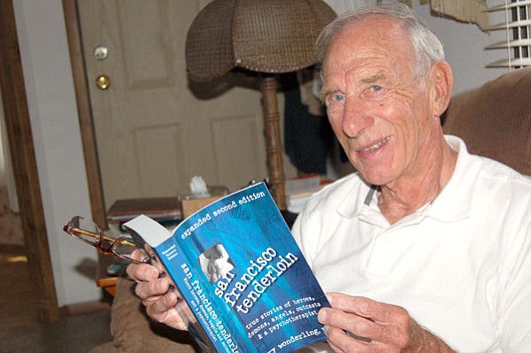 Retired psychologist Larry Wonderling displays an award-winning book he wrote about his experiences working in the Tenderloin District of San Francisco. (Ken Hedler/The Daily Courier)