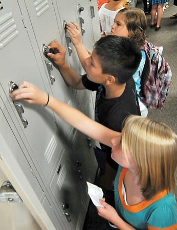 Les Stukenberg/The Daily Courier<br>
Students work the combinations on their new lockers before the start of the first day of classes at Prescott Mile High Middle School on Monday.