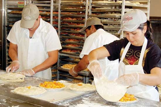 Jason Soifer/<br>The Daily Courier<br>Employees work on pies at the Rock Springs Caf&#233; Thursday afternoon. Co-owner Augie Perry said they sold more than 60,000 pies in 2008.